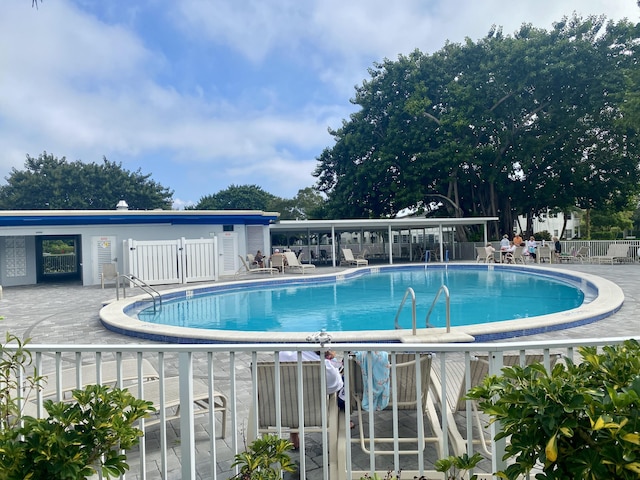 2060 Newport N, Deerfield Beach, FL 33442 - community pool with fence and a patio area