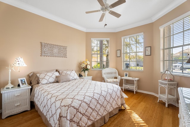 1629 SE Tradition Trce, Stuart, FL 34997 - bedroom with ornamental molding, light wood-style flooring, baseboards, and a ceiling fan