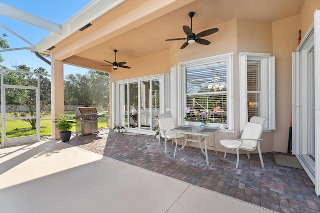 1629 SE Tradition Trce, Stuart, FL 34997 - view of patio with grilling area, ceiling fan, and glass enclosure