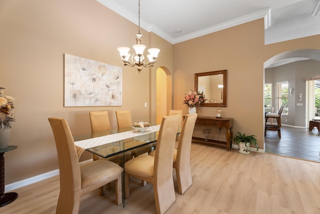 1629 SE Tradition Trce, Stuart, FL 34997 - dining room featuring arched walkways, light wood-style flooring, crown molding, baseboards, and a chandelier