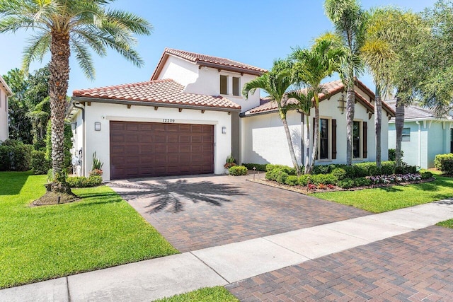 12209 Boca Reserve Ln, Boca Raton, FL 33428 - mediterranean / spanish-style home featuring a garage, stucco siding, a front lawn, decorative driveway, and a tile roof