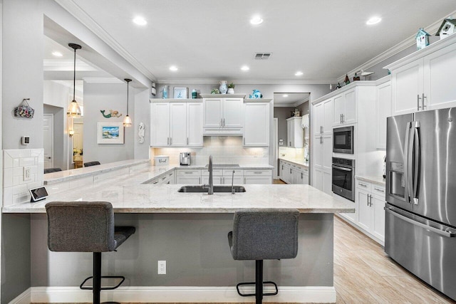 12209 Boca Reserve Ln, Boca Raton, FL 33428 - kitchen with black appliances, a kitchen bar, a sink, decorative backsplash, and white cabinetry