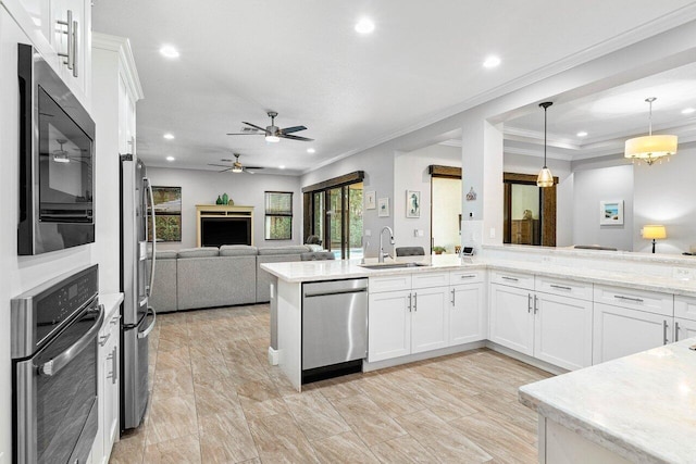 12209 Boca Reserve Ln, Boca Raton, FL 33428 - kitchen featuring stainless steel appliances, a sink, recessed lighting, white cabinets, and open floor plan