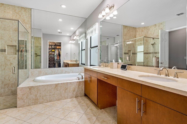 12209 Boca Reserve Ln, Boca Raton, FL 33428 - bathroom with double vanity, a shower stall, tile patterned flooring, a walk in closet, and a garden tub