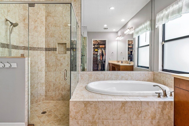 12209 Boca Reserve Ln, Boca Raton, FL 33428 - full bath featuring a bath, a stall shower, a walk in closet, recessed lighting, and vanity