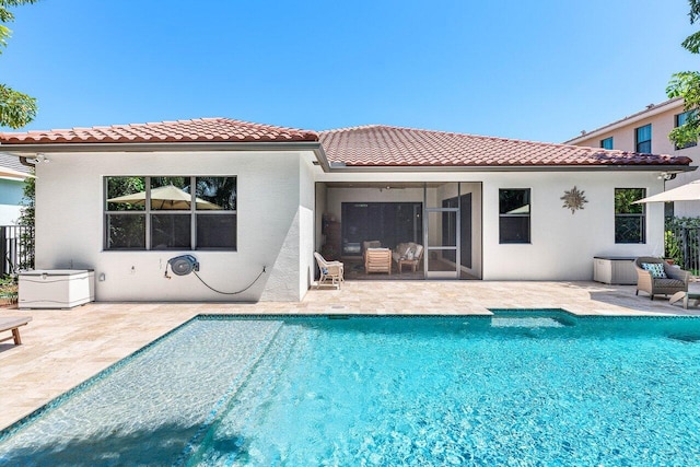 12209 Boca Reserve Ln, Boca Raton, FL 33428 - back of house with a tile roof, a patio, stucco siding, and an outdoor pool