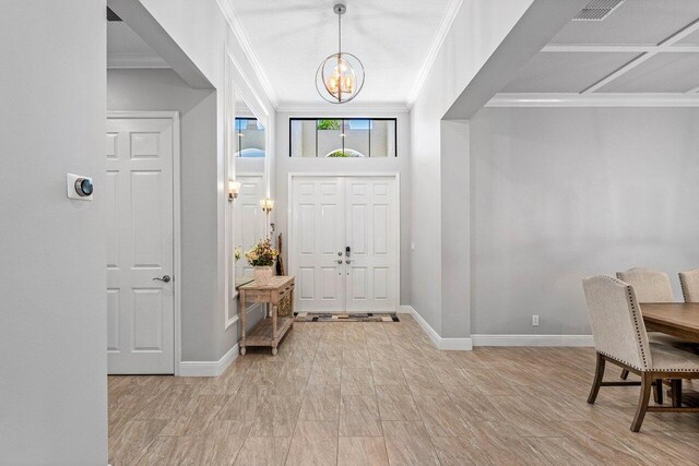 12209 Boca Reserve Ln, Boca Raton, FL 33428 - foyer featuring a chandelier, baseboards, and ornamental molding