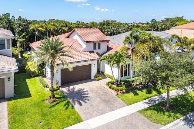 12209 Boca Reserve Ln, Boca Raton, FL 33428 - mediterranean / spanish home with a tiled roof, stucco siding, decorative driveway, a garage, and a front yard