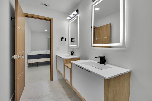 8269 Springtree Rd, Boca Raton, FL 33496 - bathroom featuring marble finish flooring, connected bathroom, two vanities, recessed lighting, and baseboards