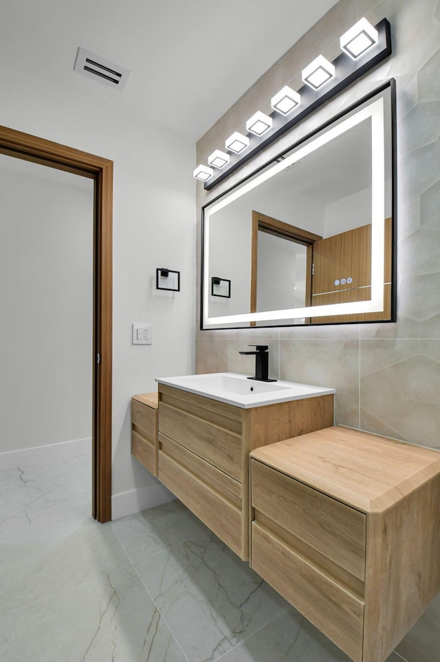 8269 Springtree Rd, Boca Raton, FL 33496 - bathroom with marble look tile flooring, vanity, and baseboards