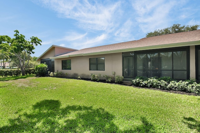 8269 Springtree Rd, Boca Raton, FL 33496 - rear view of house featuring a lawn, stucco siding, and a sunroom