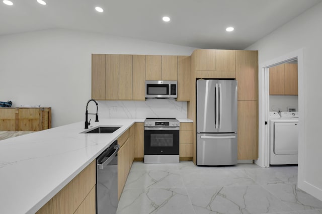 8269 Springtree Rd, Boca Raton, FL 33496 - kitchen featuring appliances with stainless steel finishes, a sink, washer and clothes dryer, light marble finish flooring, and recessed lighting
