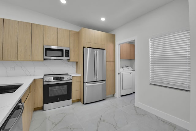 8269 Springtree Rd, Boca Raton, FL 33496 - kitchen with appliances with stainless steel finishes, washer and dryer, light marble finish floors, recessed lighting, and tasteful backsplash