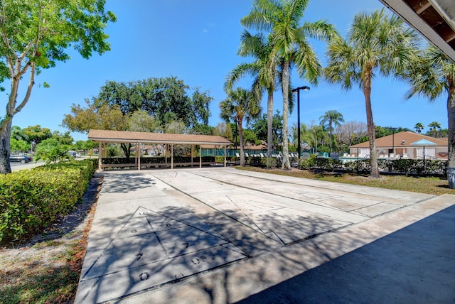 8269 Springtree Rd, Boca Raton, FL 33496 - surrounding community featuring shuffleboard, a carport, and driveway