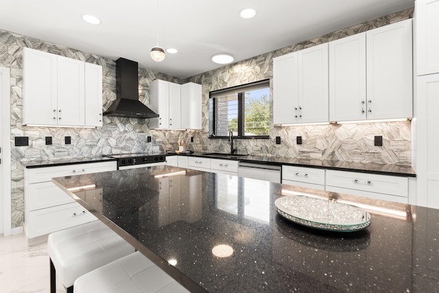 1428 N M St, Lake Worth Beach, FL 33460 - kitchen featuring wall chimney range hood, a sink, dishwasher, white cabinetry, and tasteful backsplash