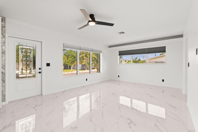 1428 N M St, Lake Worth Beach, FL 33460 - spare room featuring marble finish flooring, ceiling fan, and baseboards