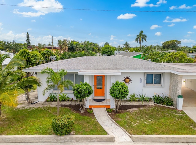 1428 N M St, Lake Worth Beach, FL 33460 - ranch-style home featuring a shingled roof, a front lawn, an attached carport, and driveway