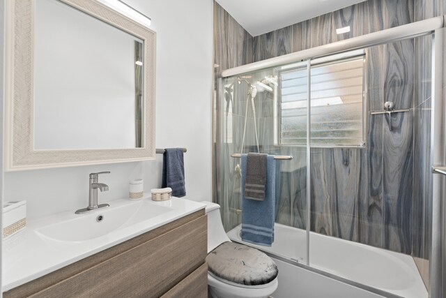 1428 N M St, Lake Worth Beach, FL 33460 - bathroom featuring vanity, toilet, and bath / shower combo with glass door