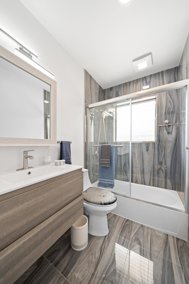 1428 N M St, Lake Worth Beach, FL 33460 - bathroom featuring shower / bath combination with glass door, toilet, and vanity