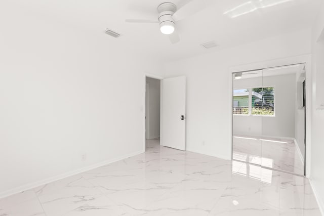1428 N M St, Lake Worth Beach, FL 33460 - empty room with marble finish floors, baseboards, and ceiling fan