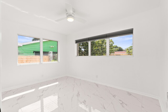 1428 N M St, Lake Worth Beach, FL 33460 - empty room with baseboards, marble finish floors, and a ceiling fan