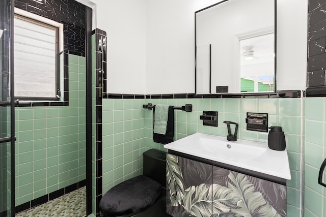 1428 N M St, Lake Worth Beach, FL 33460 - full bath with toilet, a stall shower, vanity, tile walls, and wainscoting