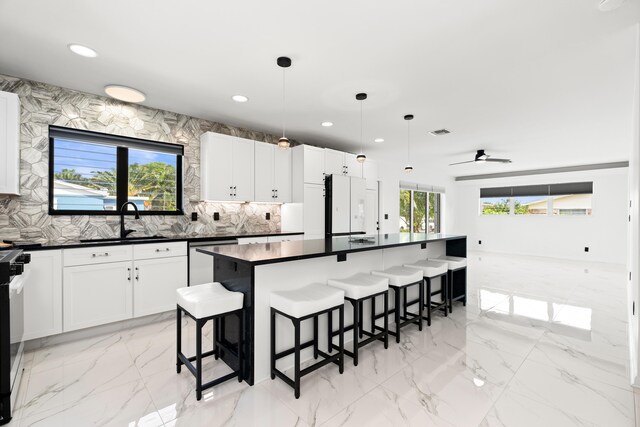 1428 N M St, Lake Worth Beach, FL 33460 - kitchen with a sink, dishwasher, dark countertops, freestanding refrigerator, and recessed lighting