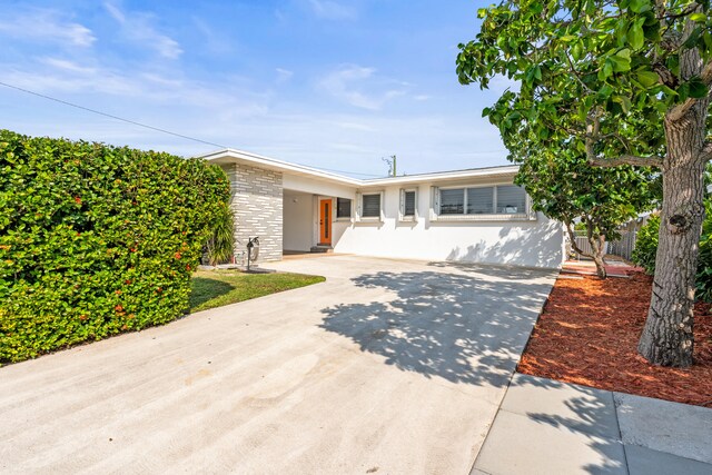 1428 N M St, Lake Worth Beach, FL 33460 - view of front facade with concrete driveway and stucco siding