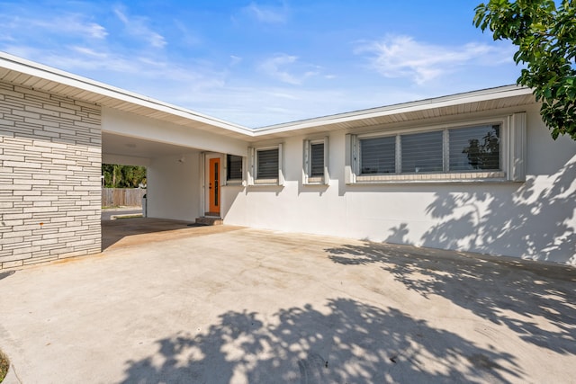 1428 N M St, Lake Worth Beach, FL 33460 - view of patio featuring concrete driveway and an attached carport