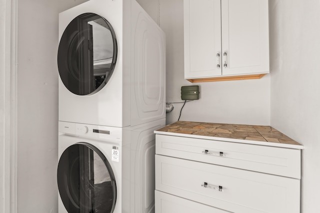 1428 N M St, Lake Worth Beach, FL 33460 - laundry area with stacked washer / drying machine and cabinet space