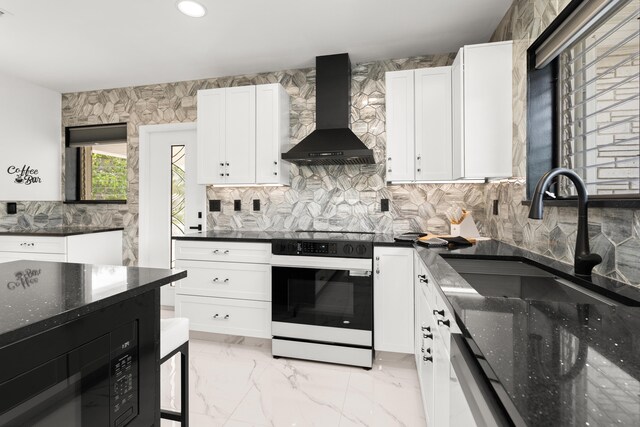1428 N M St, Lake Worth Beach, FL 33460 - kitchen with wall chimney range hood, white range with electric cooktop, a sink, dishwashing machine, and white cabinets