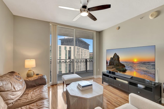 550 Okeechobee Blvd Unit 821, West Palm Beach, FL 33401 - living area with ceiling fan, wood finished floors, baseboards, and expansive windows