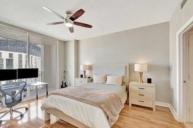 550 Okeechobee Blvd Unit 821, West Palm Beach, FL 33401 - bedroom with wood finished floors, baseboards, a desk, a ceiling fan, and access to exterior