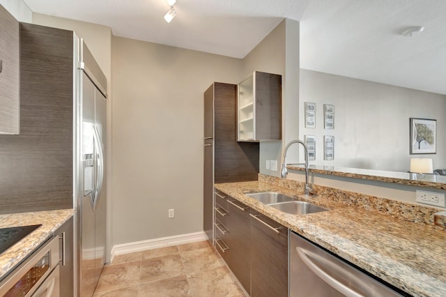 550 Okeechobee Blvd Unit 821, West Palm Beach, FL 33401 - kitchen with a sink, stainless steel appliances, baseboards, light stone counters, and modern cabinets