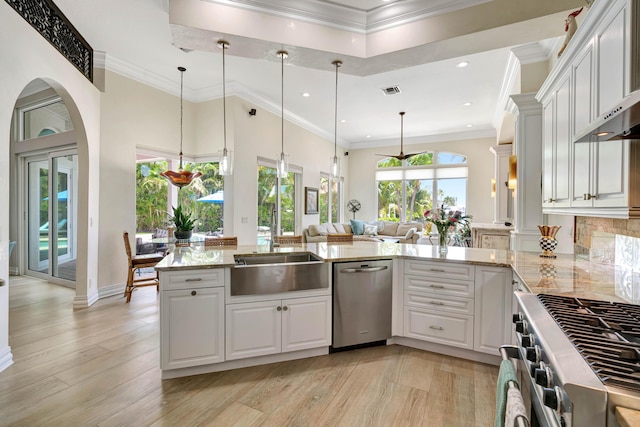506 Corsair Dr, North Palm Beach, FL 33408 - kitchen featuring stainless steel appliances, light stone countertops, white cabinets, light wood-type flooring, and recessed lighting