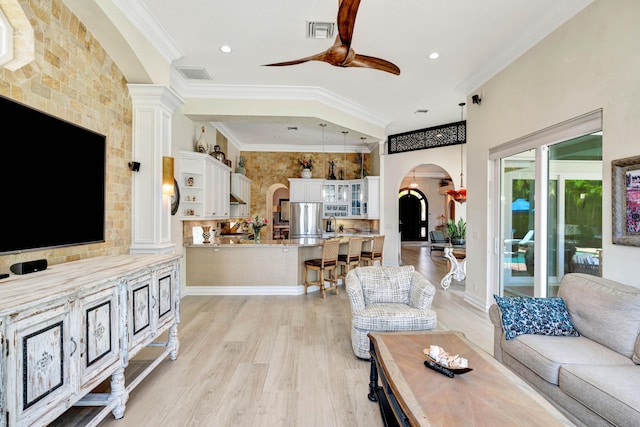 506 Corsair Dr, North Palm Beach, FL 33408 - living area with arched walkways, ceiling fan, light wood finished floors, ornamental molding, and recessed lighting