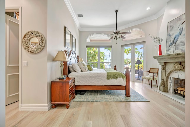 506 Corsair Dr, North Palm Beach, FL 33408 - bedroom featuring access to exterior, wood finished floors, ornamental molding, a fireplace, and baseboards