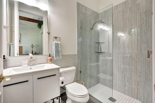 506 Corsair Dr, North Palm Beach, FL 33408 - full bathroom featuring tiled shower, toilet, vanity, and tile walls