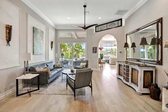 506 Corsair Dr, North Palm Beach, FL 33408 - living area with light wood-type flooring, arched walkways, ornamental molding, a ceiling fan, and recessed lighting