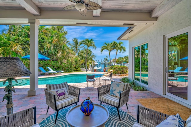 506 Corsair Dr, North Palm Beach, FL 33408 - swimming pool featuring ceiling fan, a patio, and outdoor lounge area