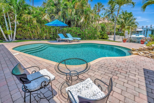 506 Corsair Dr, North Palm Beach, FL 33408 - swimming pool featuring a patio