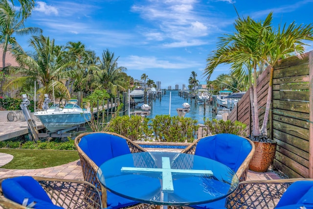 506 Corsair Dr, North Palm Beach, FL 33408 - view of patio featuring boat lift, a water view, a boat dock, and outdoor dining area