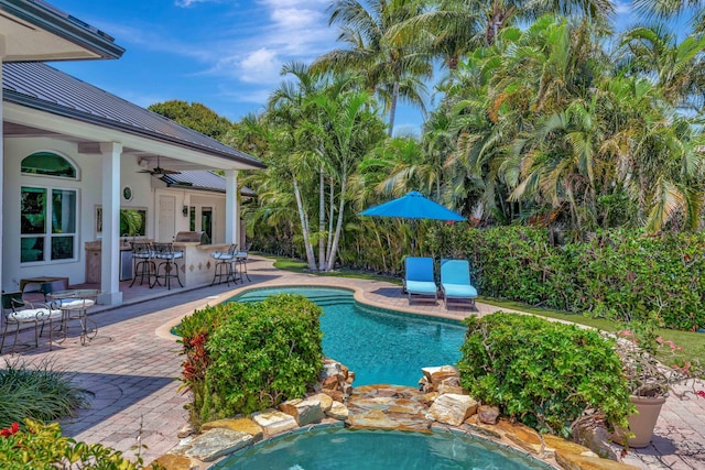 506 Corsair Dr, North Palm Beach, FL 33408 - outdoor pool featuring a ceiling fan, a patio, and a hot tub