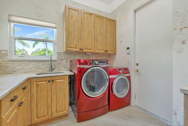 506 Corsair Dr, North Palm Beach, FL 33408 - washroom with cabinet space, washing machine and dryer, light wood finished floors, and crown molding