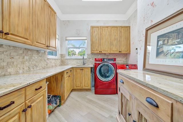 506 Corsair Dr, North Palm Beach, FL 33408 - washroom with washer / clothes dryer, cabinet space, light wood-style flooring, and crown molding