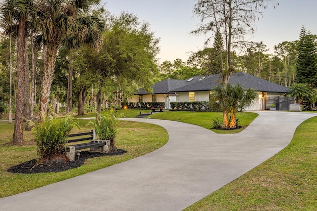 9544 Mockingbird Trl, Jupiter, FL 33478 - view of property's community with curved driveway and a yard