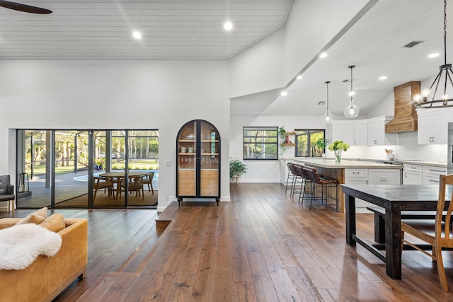 9544 Mockingbird Trl, Jupiter, FL 33478 - dining space with high vaulted ceiling, dark wood-style floors, baseboards, and recessed lighting
