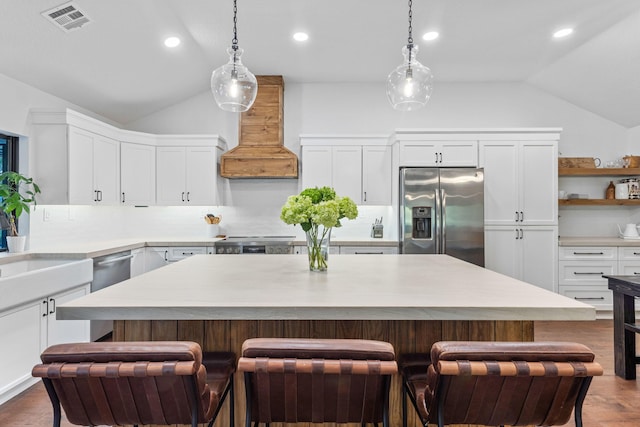 9544 Mockingbird Trl, Jupiter, FL 33478 - kitchen featuring stainless steel refrigerator with ice dispenser, lofted ceiling, range, white cabinets, and recessed lighting