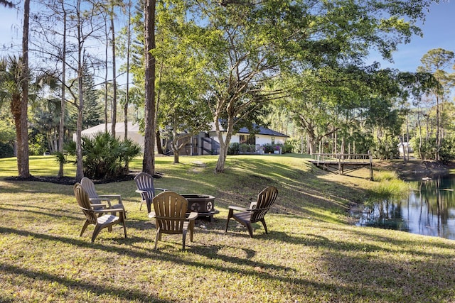 9544 Mockingbird Trl, Jupiter, FL 33478 - view of green lawn featuring an outdoor fire pit and a water view