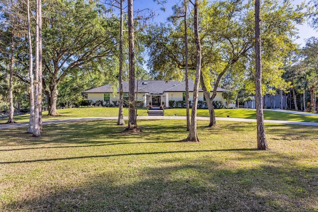 9544 Mockingbird Trl, Jupiter, FL 33478 - view of front of home with a front lawn and driveway